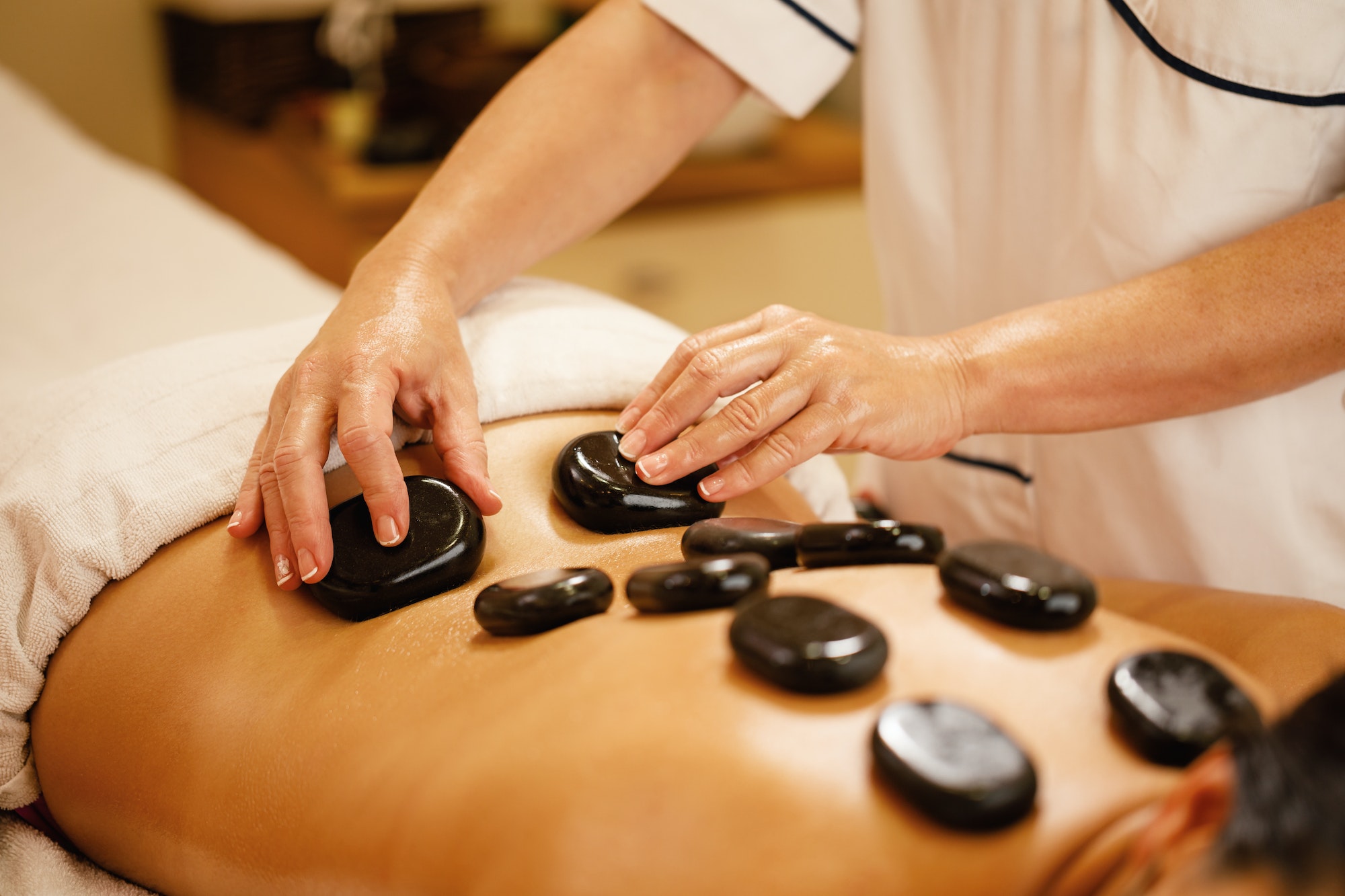 Close-up of hot stone therapy at the spa.